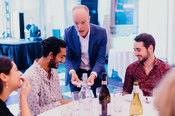 Table magician Darren Delaney performing card tricks at a dinner event