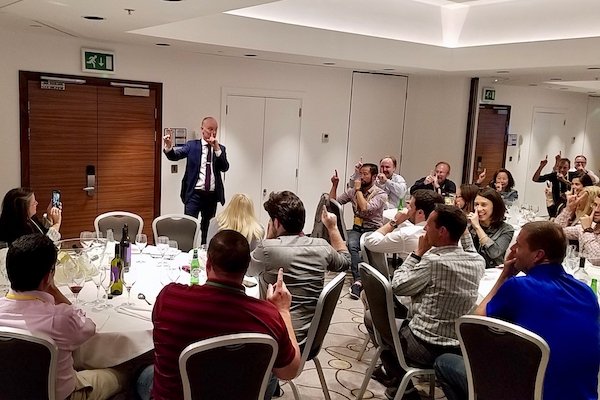 Table magician performing after-dinner show at corporate event