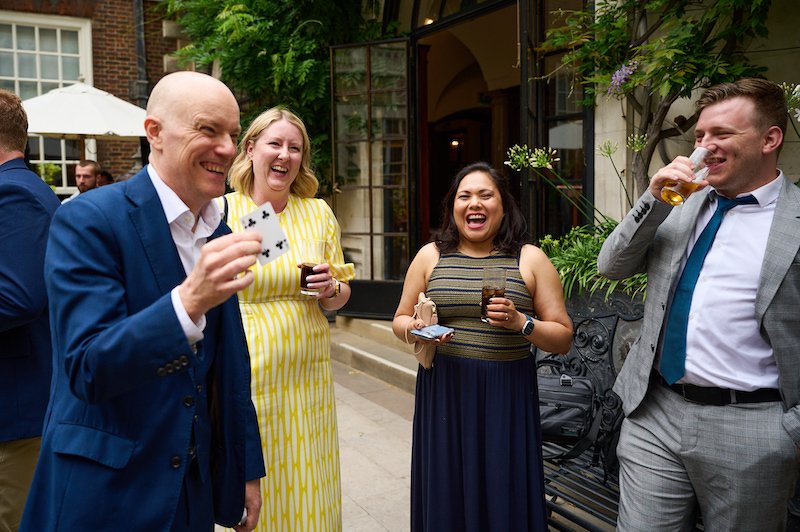 8 Great reasons to book a magician for your corporate event 15 Magician Darren Delaney performing card trick at corporate function