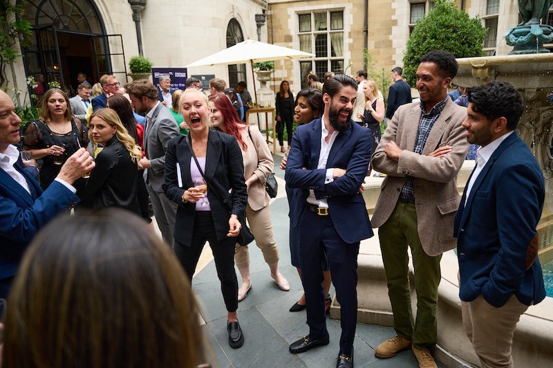 8 Great reasons to book a magician for your corporate event 7 magician Darren Delaney performing close-up card tricks at a corporate networking event