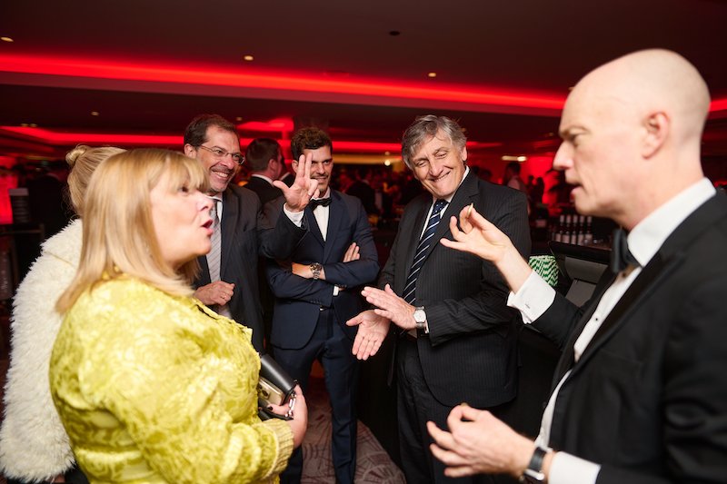 8 Great reasons to book a magician for your corporate event 9 magician Darren Delaney performing coin tricks at black tie corporate event