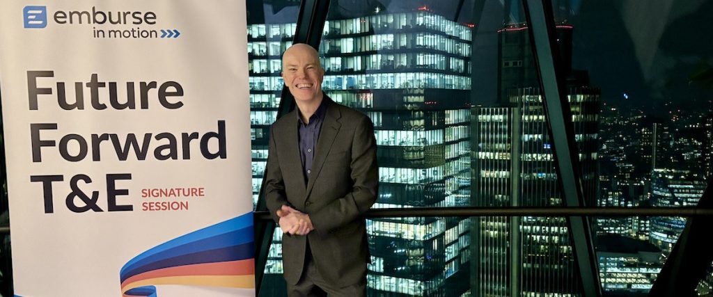 magician Darren Delaney standing next to corporate banner at Searcy's in The Gherkin, London