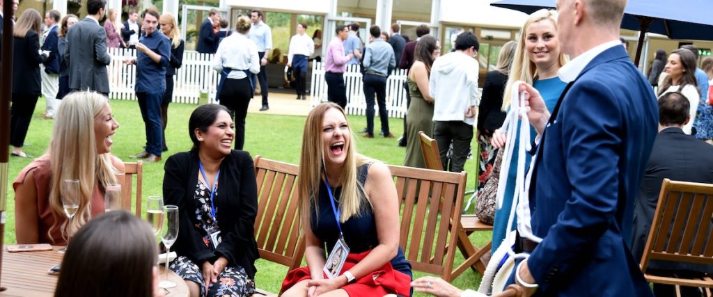 Darren Delaney performing magic at an outdoor event. Just one of many corporate summer party ideas.