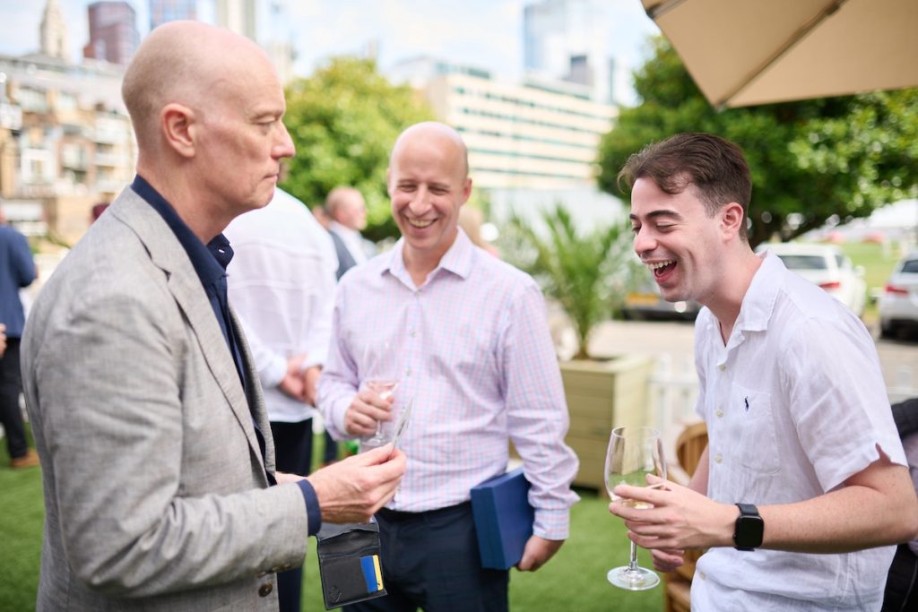Two men Reacting to Darren Delaney Magician performing card trick at Paytech Awards 2025