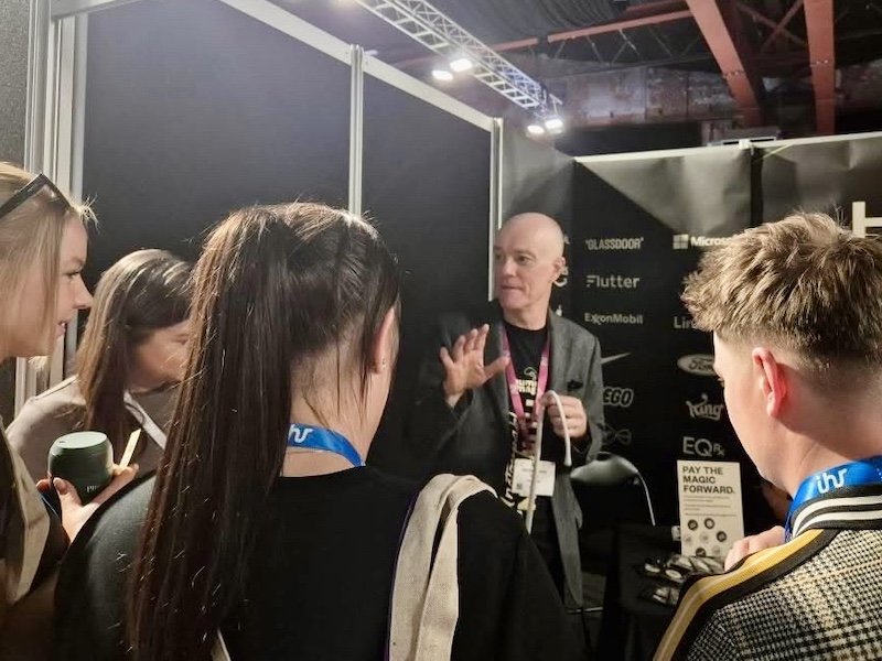 A trade show magician building a crowd on an exhibition stand