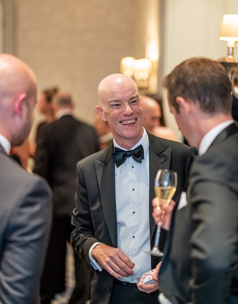 Magician Darren Delaney performing a card trick at The Private Business Awards