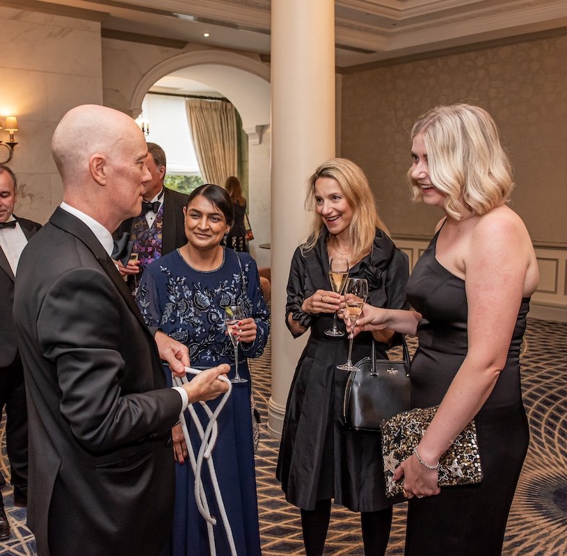 Darren Delaney performing magic with rope at a black tie drink reception