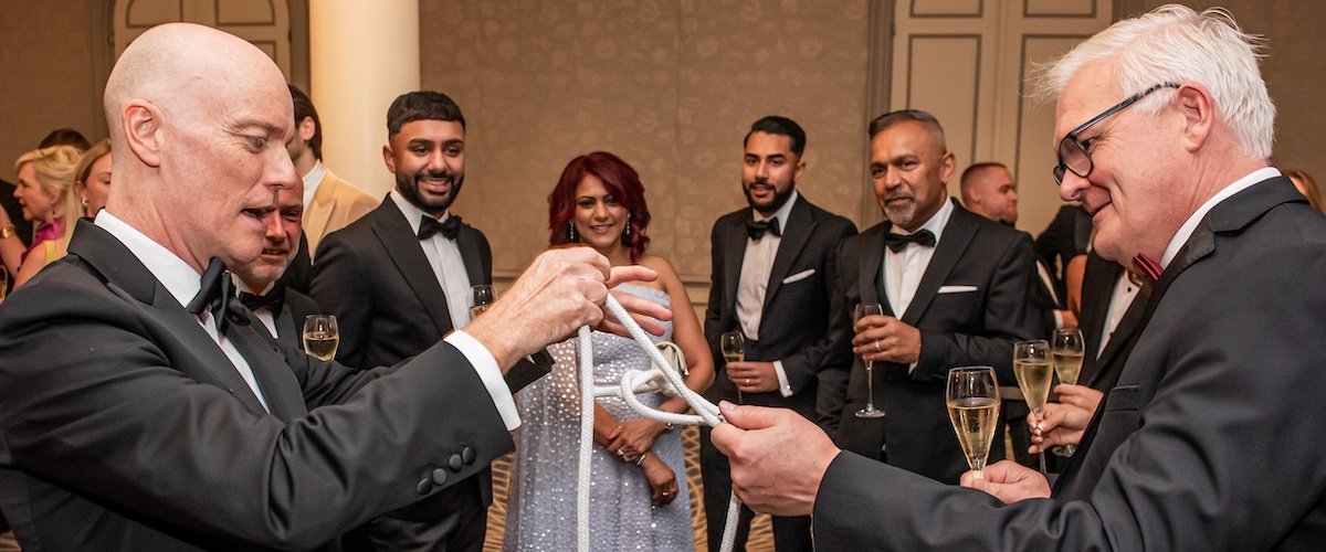 Darren Delaney performing close-up magic with rope at The Private Business Awards 2025 at the Savoy London