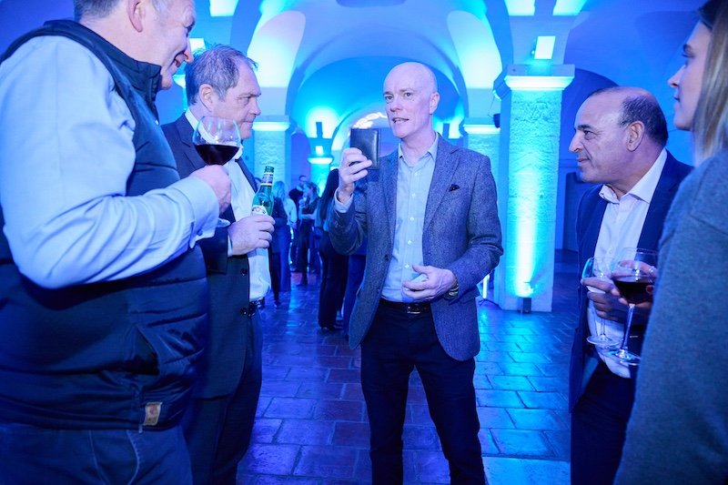 Darren Delaney magician showing his wallet to guests at an event at The Crypt at St Paul's
