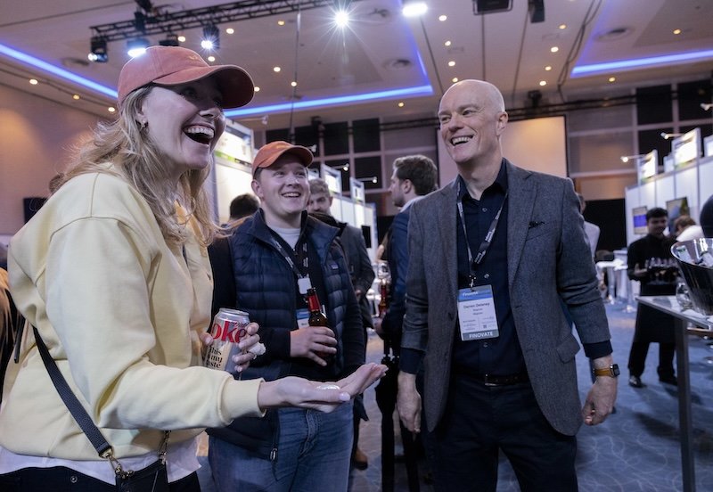 A lady reacts to a magic trick with coins performed by magician Darren Delaney at Finovate Europe 2026