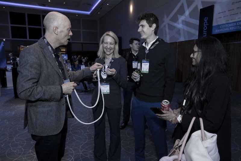 Darren Delaney performing magic with a rope for a small group at Finovate Europe 2026