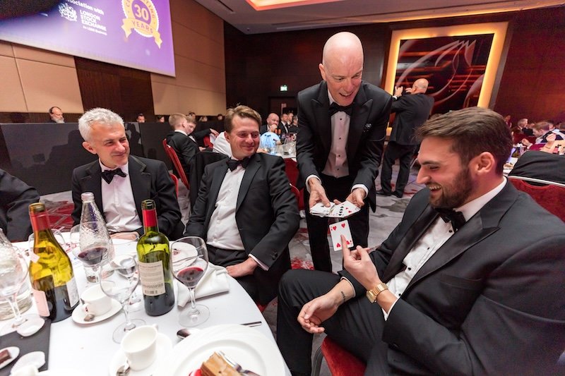 Darren Delaney performing magic at a corporate awards dinner. Hiring a magician for corporate events is a great way to make gala dinners memorable.