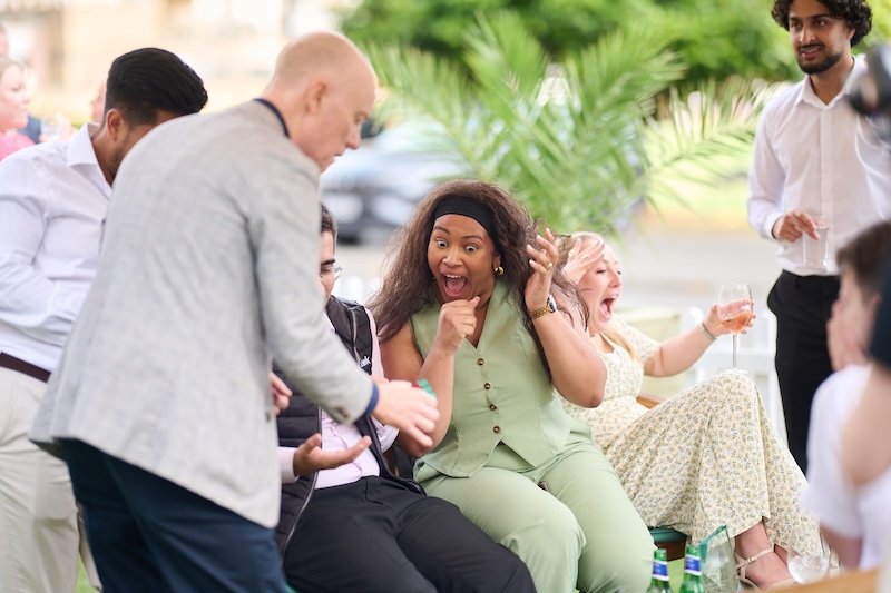 Darren Delaney performing close-up magic at a corporate summer party.