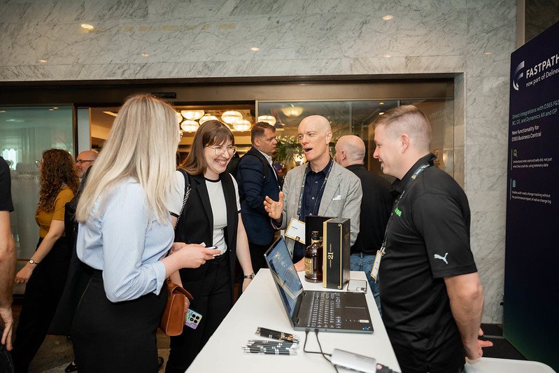 Darren Delaney talking to people on a booth at DynamicsMinds in Portorož