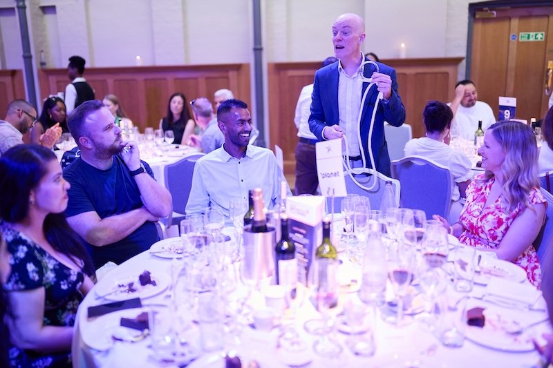 Darren Delaney performing a rope trick at a corporate dinner