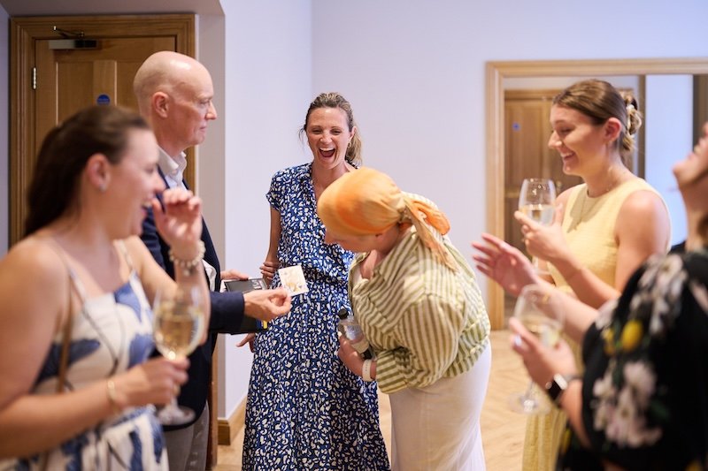 People reacting to Darren Delaney's magic at a corporate event
